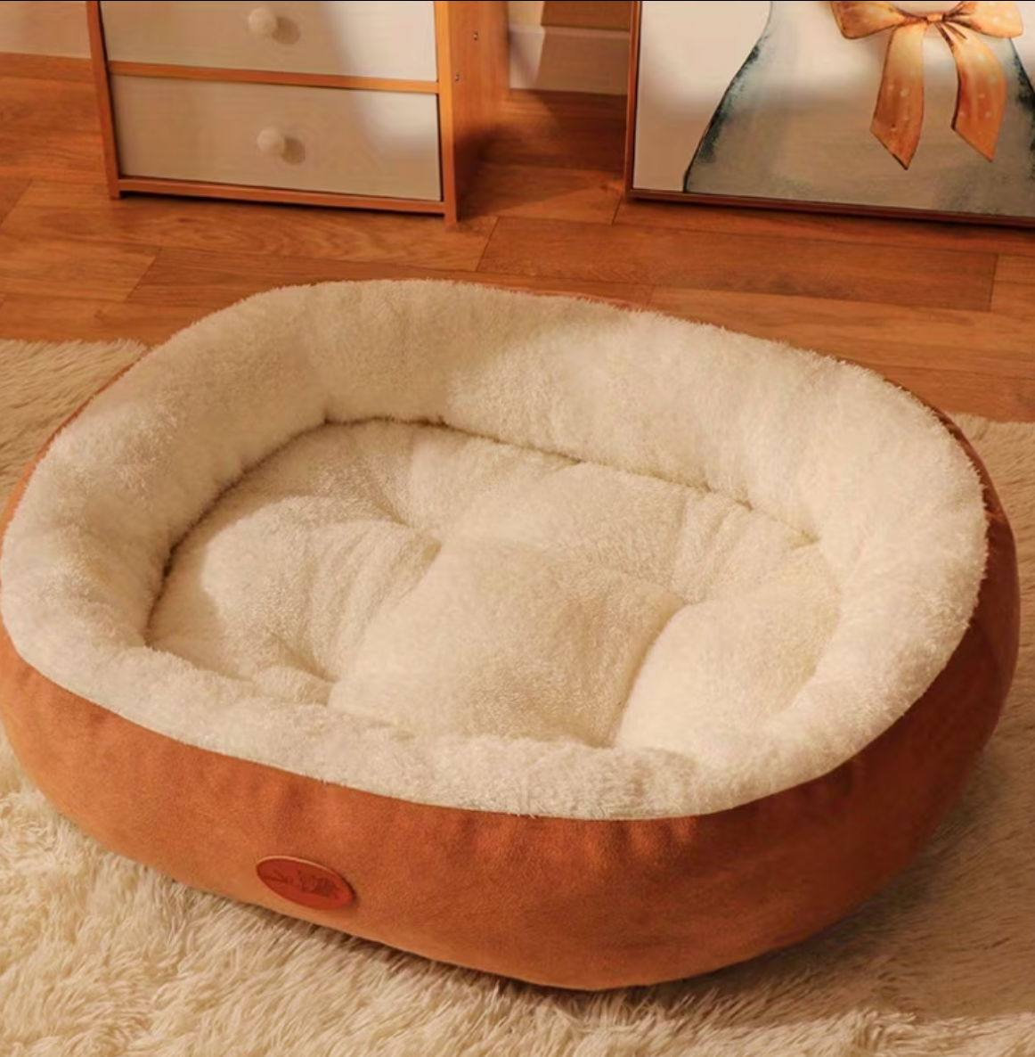 Round pet bed with plush interior on a wooden floor